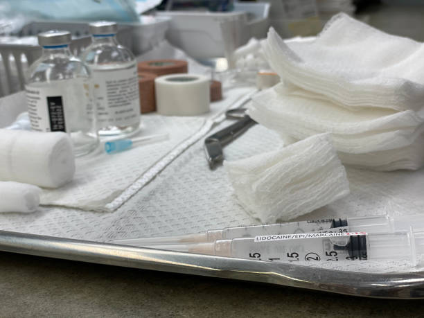syringe and medicine on metal tray with scissors, gauze, swabs, glass vials. Ready for medical procedure. No people stock photo