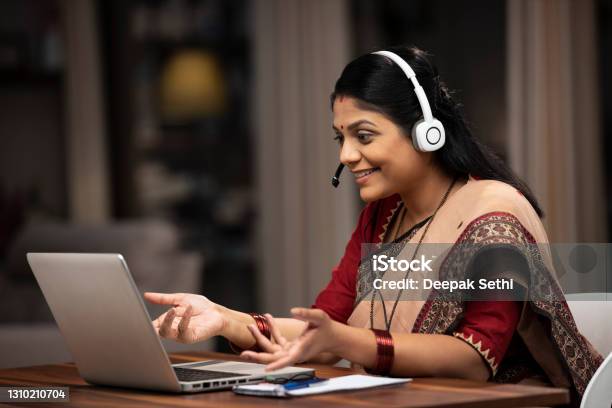 Indian Woman Customer Care Representative Sitting On Chair At Home Stock Photo Stock Photo - Download Image Now