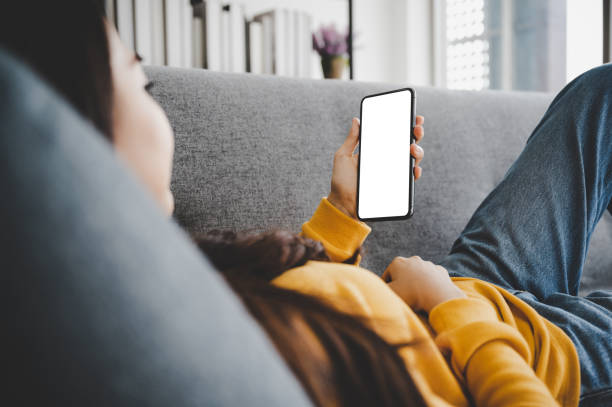 istock Woman using mobile smartphone and device white screen empty space smart phone, clipping path included 1310211377