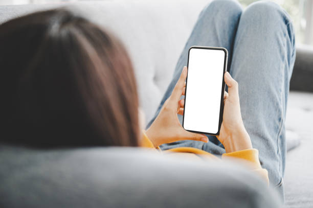 istock Woman using mobile smartphone and device white screen empty space smart phone, clipping path included 1310211391