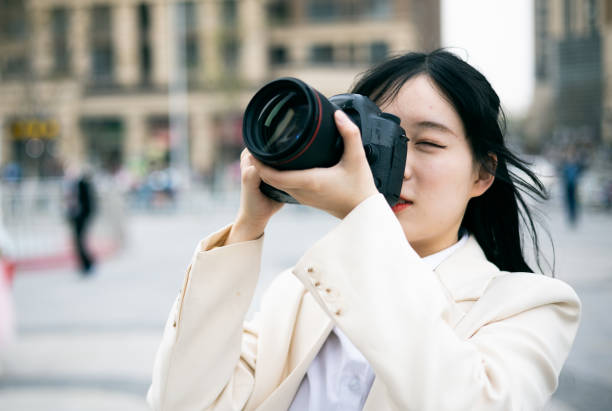 istock Asian woman taking photos with camera 1310211511