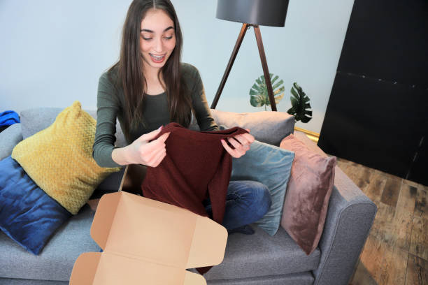istock Young woman unboxing a package 1310213203