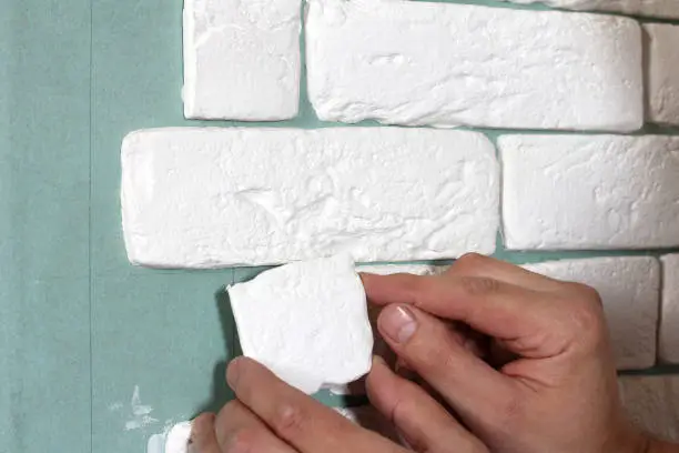 tiler to glue gypsum bricks on the wall
