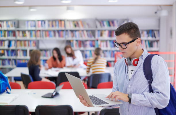 istock the student uses a notebook, latop and a school library 1310215767