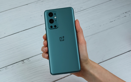 OnePlus 9 Pro 5G in Pine Green color against the white background. New York, NY, USA. April 1, 2021.