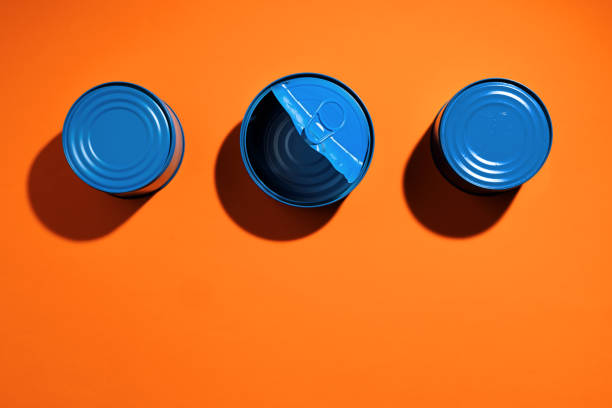 istock Aesthetic concept with blue painted tin can on orange background 1310220883