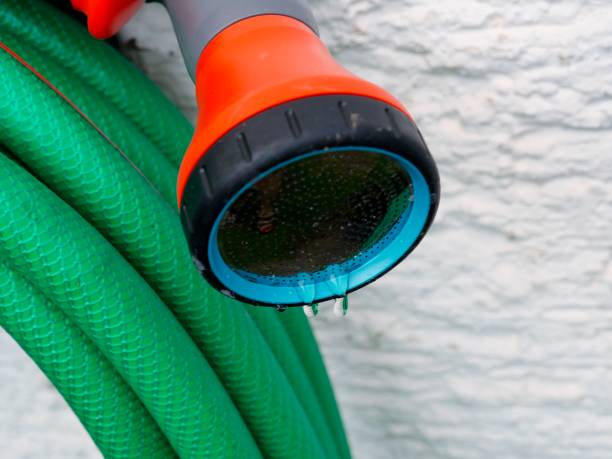 istock Green water hose with nozzle 1310221057