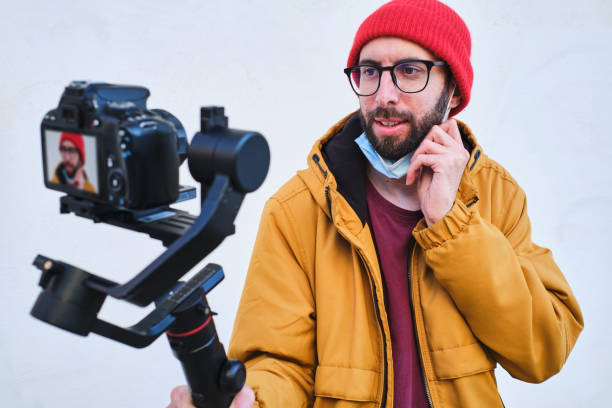 istock videographer recording himself with a dslr camera on a motorized gimbal with protective face mask 1310221167