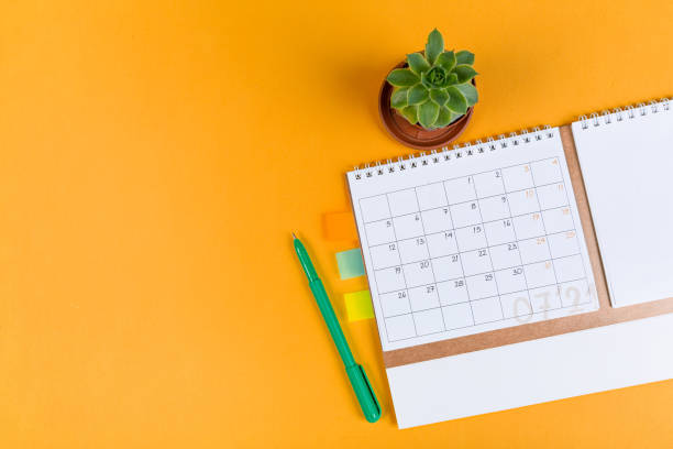 istock White blank 2021 calendar on solid orange background with copy space, business meeting schedule, travel planning or project milestone and reminder concept. 1310221990