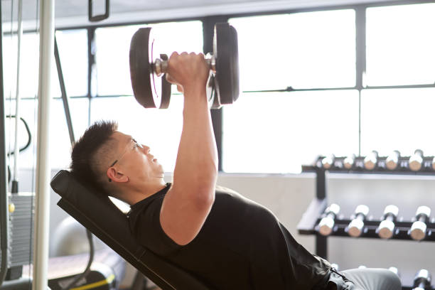 istock Asian man doing an incline dumbbell fly in a training gym 1310222279