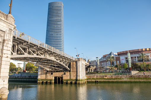 Bilbao, Biscay, Spain – March 22, 2021: Deusto Bridge and Iberdrola skyscraper in Bilbao