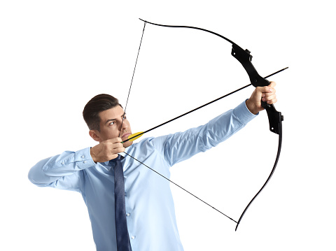 Businessman with bow and arrow practicing archery on white background
