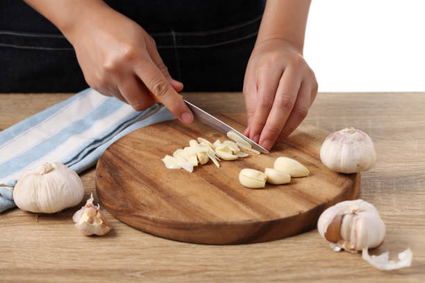 istock Chef chopped garlic on wooden cutting board in kitchen 1310224172