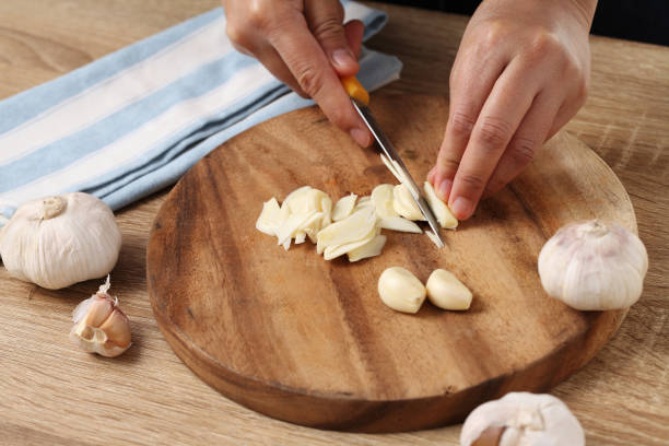 istock Chef chopped garlic on wooden cutting board in kitchen 1310225096