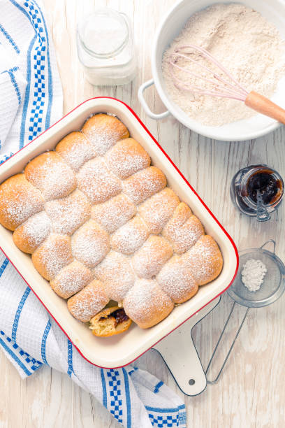 istock Sweet rolls, Buchteln filled with plum jam or jelly with backing ingredients 1310226020