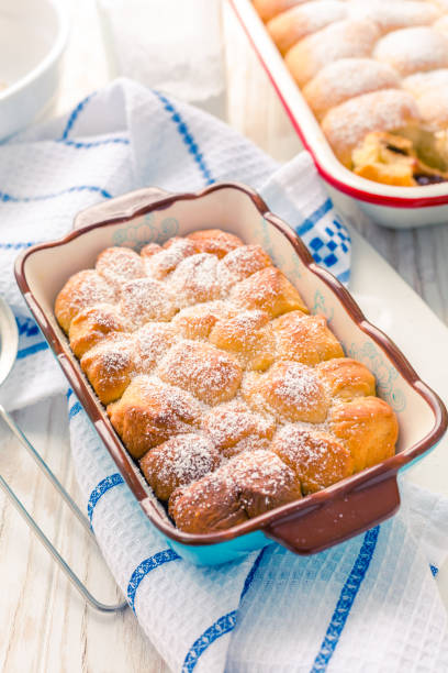 istock Sweet rolls, Buchteln filled with plum jam or jelly with backing ingredients 1310226040