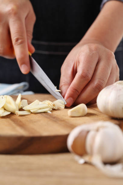 istock Chef chopped garlic on wooden cutting board in kitchen 1310226046