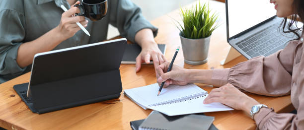 istock Cropped shot of two businesswoman working on their project and using computer tablet for checking information  in office. 1310226910