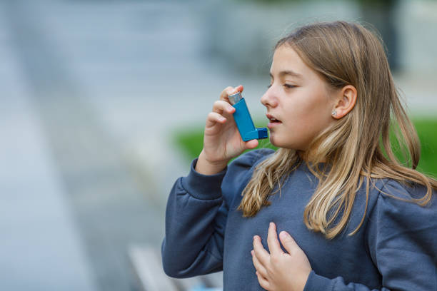 istock Cute Girl has Problems With Respiratory System so She Uses an Inhaler. 1310227070