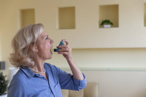 istock Senior Woman with Asthma is Using an Inhaler. 1310227322