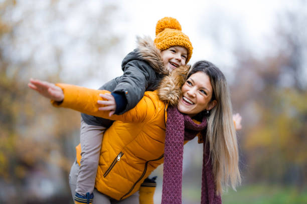 istock Cheerful single mother and her small piggybacking in nature. 1310228164