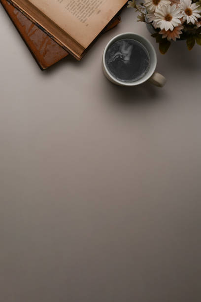 istock Above view of coffee cup, notebook and copy space on white office desk. 1310228742
