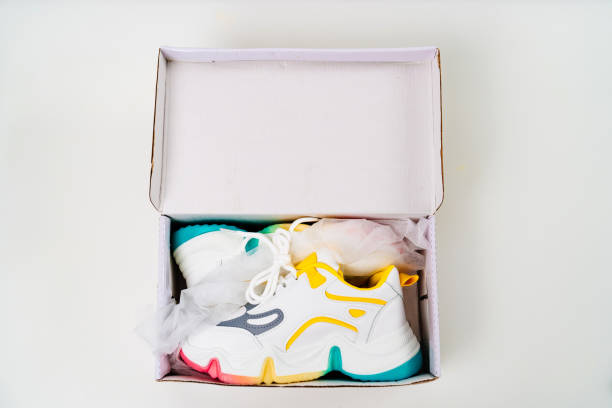 istock new multi-colored sneakers in box on a white background. 1310228905