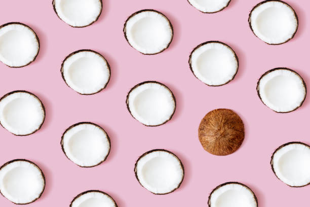 istock Coconut pattern on the pink background. Set of coconut halves 1310231669