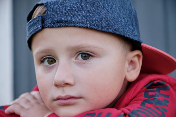 Young Black male putting on a hat. CLICK FOR SIMILAR IMAGES AND LIGHTBOX WITH MORE MEN.
