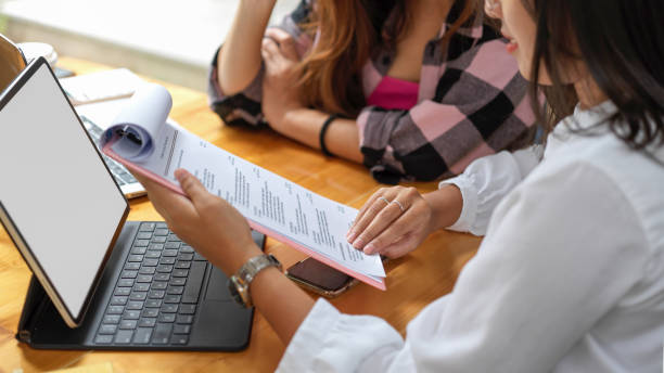 istock Two female students brainstorming on their homework with digital tablet and paperwork 1310233492