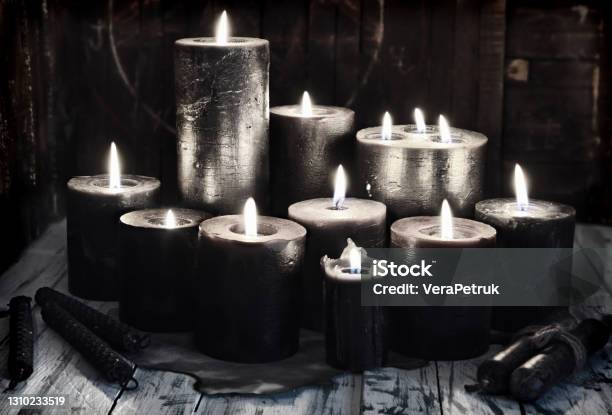 Group Of Black Burning Candles On Witch Table Grunge Style Stock Photo - Download Image Now