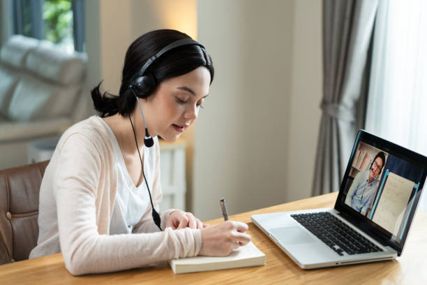 istock Homeschool Caucasian cute young girl student learning virtual internet online class from school teacher by remote meeting due to covid pandemic. Male teacher teaching math calculus by using whiteboard 1310234700