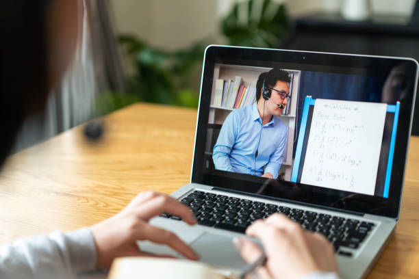 istock Homeschool Caucasian cute young girl student learning virtual internet online class from school teacher by remote meeting due to covid pandemic. Male teacher teaching math calculus by using whiteboard 1310234709