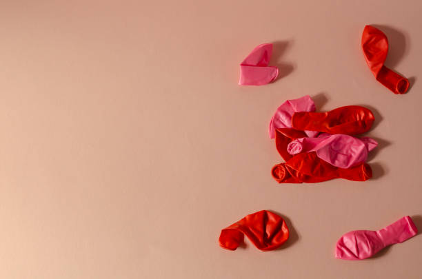 istock Minimalistic composition with deflated balloons on a pink backgr 1310234833