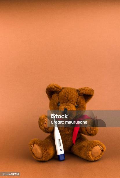 Teddy Bear Is Sick Teddy Bear Toy And Thermometer On A Brown Background With Copy Space Stock Photo - Download Image Now