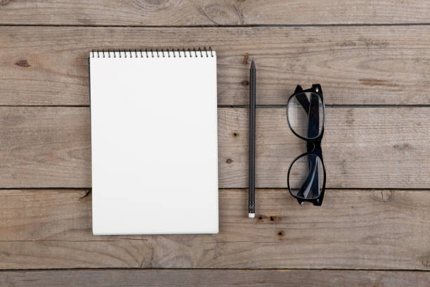 istock Notepad, glasses on the wooden desk 1310235478