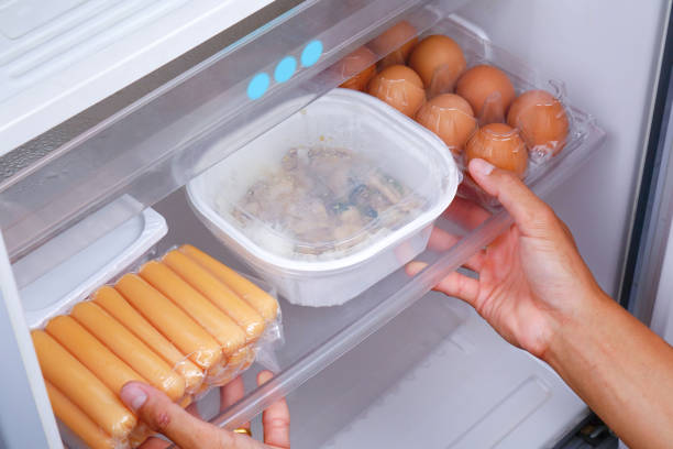istock A man is putting the food in the refrigerator. 1310235547