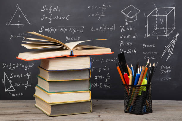 istock Education concept - books on the desk in the auditorium 1310235565