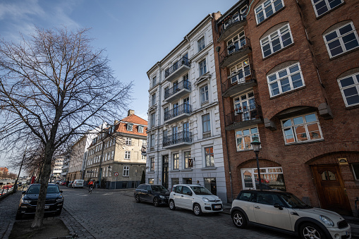 Beautiful old apartment buildings from around the turn of the 20th century in Christianshavn, Copenhagen.\nChristianshavn is a district in Copenhagen founded by king Christian IV in 1618 to protect Copenhagen's inner harbor.