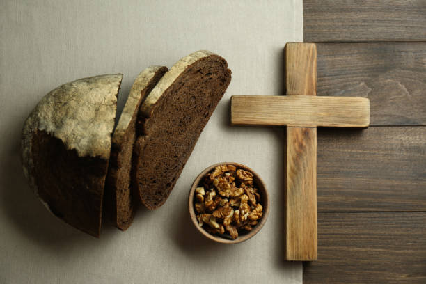 istock Bread, walnuts and cross on wooden table, flat lay 1310236326