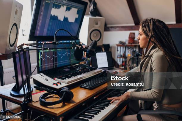 Dedicated Young Woman An Audio Engeener Working On Sound Mixing From Her Music And Sound Record Studio Stock Photo - Download Image Now