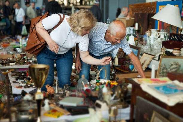 mature man and his wife are visiting market of old things - swap meets imagens e fotografias de stock