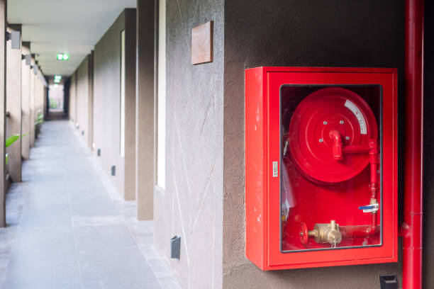 istock Fire extinguisher and water pump system on the wall background, powerful emergency equipment for industrial and residential 1310247969