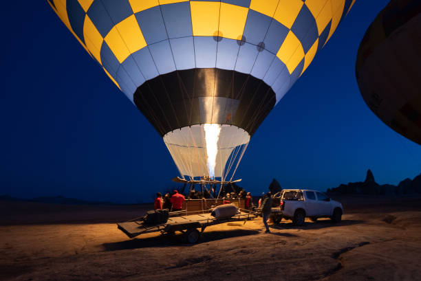 hot air balloons near cars at night, cappadocia, - cappadocia hot air balloon turkey basket imagens e fotografias de stock