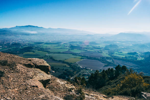 landscape from the top of a mountain overlooking green cultivated fields