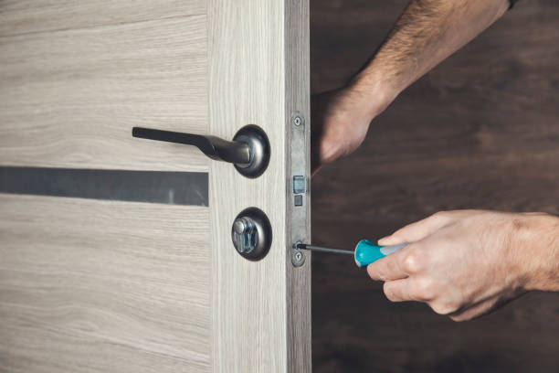 istock The man is installing the door by the screwdriver 1310249256