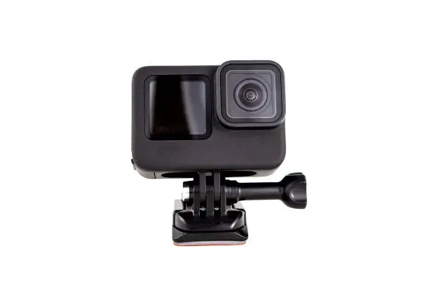 Photo of New 4K action camera on a suction mount in black color. Isolated white background