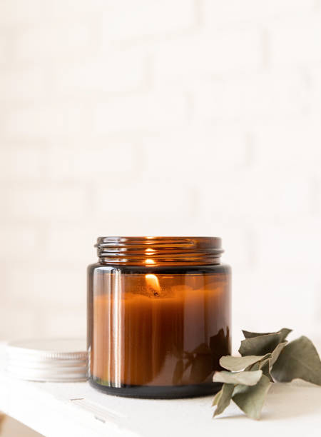 istock Beautiful burning candle with eucalyptus leaves 1310250358