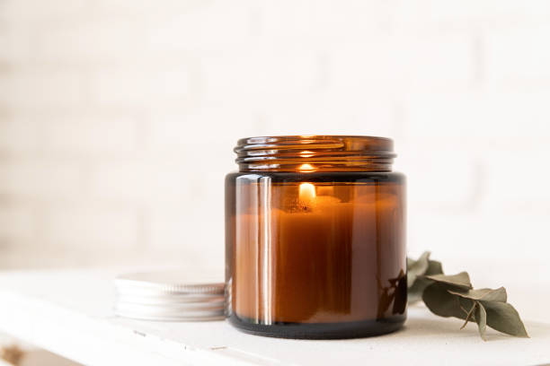 istock Beautiful burning candle with eucalyptus leaves 1310251627