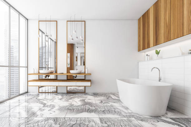 istock White and wooden bathroom with two sinks and bathtub on tiled marble floor 1310254171